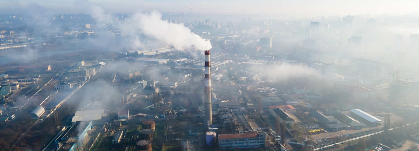 Aerial view of an industrial district with a smoking chimney
