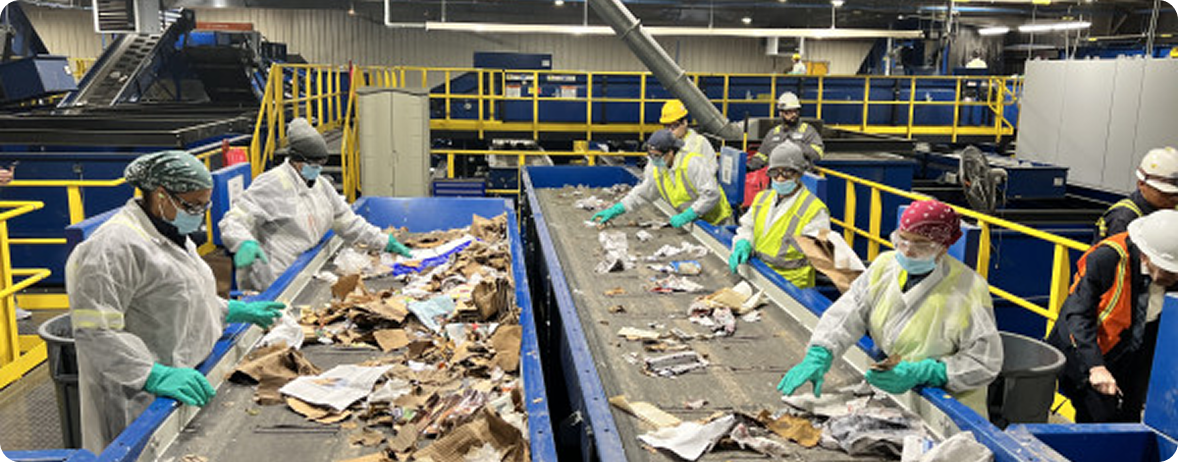 Workers sorting recovered materials on a conveyor line