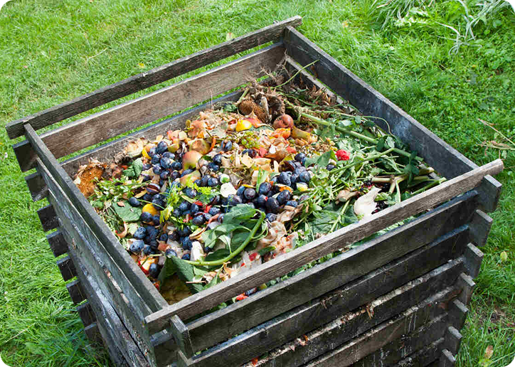 Wooden compost bin filled with organic waste